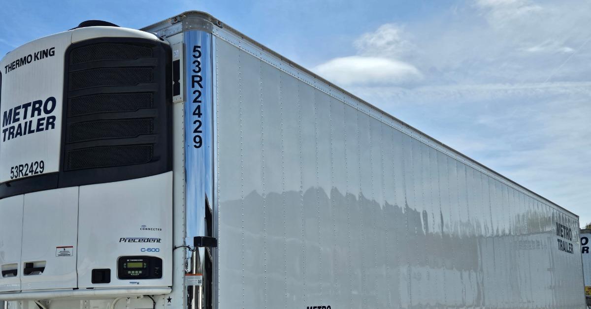 A refrigerated Metro Trailer semi-trailer parked outdoors, showing a white front unit and long silver trailer side.